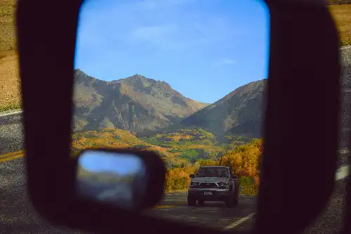 photo containing: Mode of transport, Mountainous landforms, Automotive Exterior, Rear-view mirror, Automotive Mirror, Hill, Mirror, Automotive Side-View Mirror, Glass, Windshield