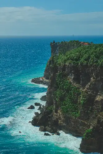 photo containing: Blue, Water, Coast, Body of water, Coastal and oceanic landforms, Rock, Sea, Natural landscape, Headland, Terrain, temple