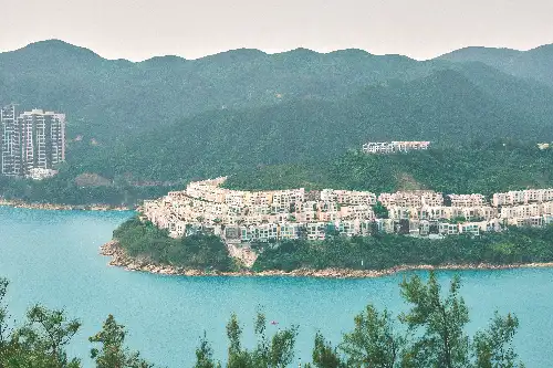 photo containing: Water resources, Body of water, Coastal and oceanic landforms, Coast, Waterway, Residential area, Hill, Sea, Bank, Headland
