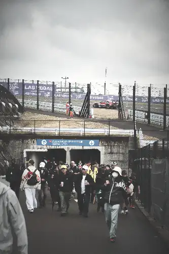 photo containing: Crowd, Pedestrian, Walking, Fence