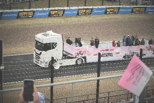 photo containing: Commercial vehicle, Sports venue, Logo, Truck, Advertising, Motorsport, Auto racing, Race track, Racing, Performance car